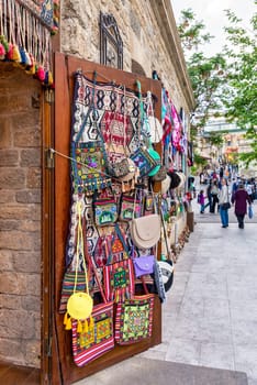 Baku, Azerbaijan - May 4, 2024: A shop in the historic Icherisheher district sells colorful woven rugs, bags, and other traditional goods
