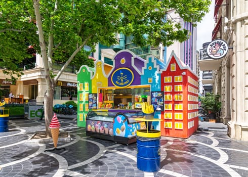 Baku, Azerbaijan - May 5, 2024: A vibrant food kiosk located on Nizami Street prominently displays a Holland Fries sign, showcasing an array of delectable food items