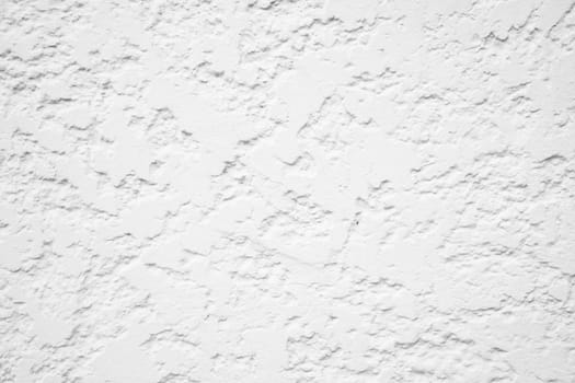Close up of textured white stucco wall surface.