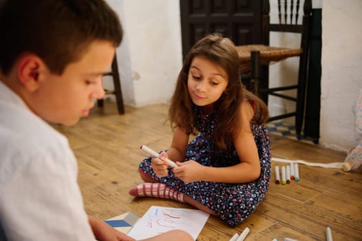 Children expressing creativity while drawing together in a cozy home setting, fostering imagination and bonding.