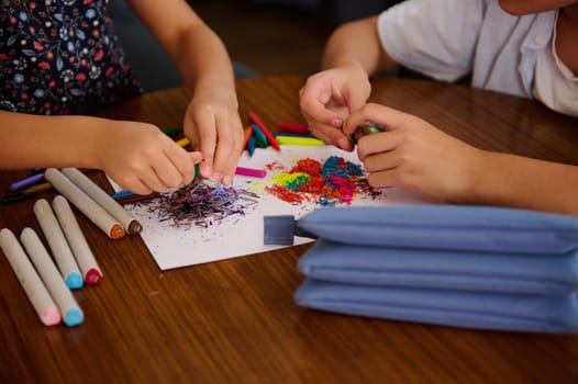 Children using vibrant materials for artwork, showcasing creativity and collaboration during a hands-on activity. Colors and craft supplies featured prominently.