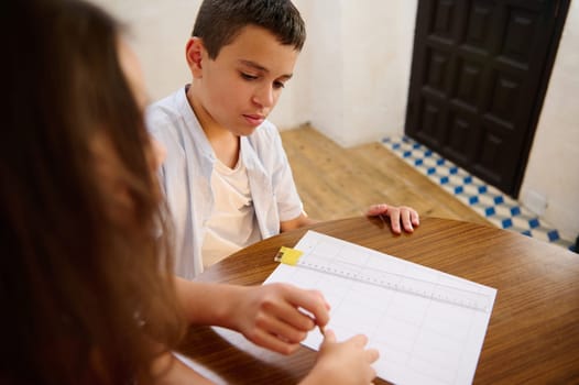Two children working together on a classroom activity, focusing on teamwork and learning.
