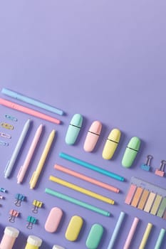 Stationery banner in green, yellow, pink and blue pastel colors on light purple background. Space for your text.
