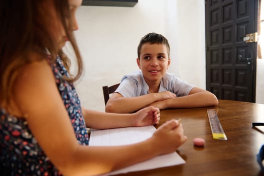 Two children interacting during a classroom activity, with a focus on engagement, teamwork, and learning. The scene shows a warm and collaborative environment enhancing educational experiences.
