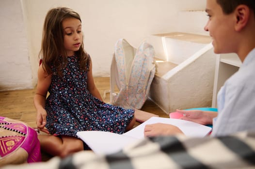 Two children are engaged in a cooperative academic activity, showcasing teamwork and learning.