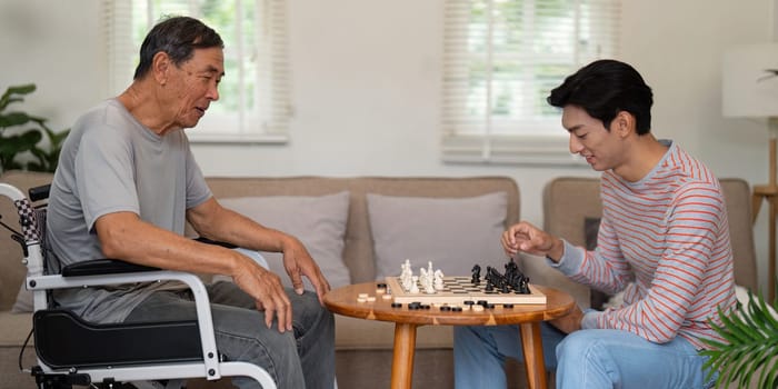 A father and son share a joyful chess game, illustrating their bond and the importance of quality time spent together at home.