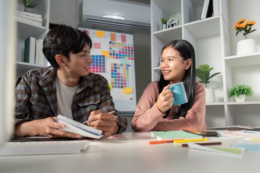 A diverse team working together on graphic design projects while sharing ideas and creativity in a modern office environment.