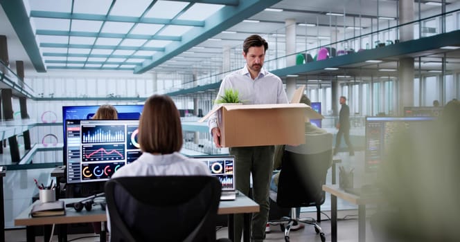 Employee decides to resign from office job, moving box packed.