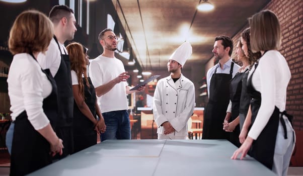 Motivated Restaurant Staff Collaborate with Diverse Team in Meeting