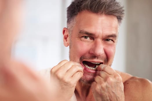 Man Flossing Teeth. Cleaning Tooth Close Up