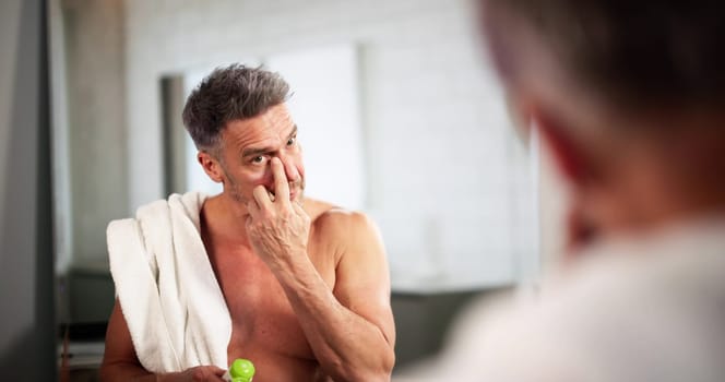 Man Skincare Using Face Cream. Looking In Mirror
