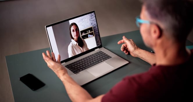 Person Having Video Chat With Woman On Laptop