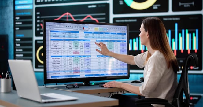 Woman Analyzing Medical Billing Data at Business Office Using Computer.