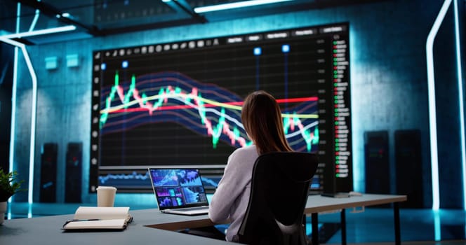 Analyzing Stock Data on Computer Screen: Businesswoman in Financial Office.