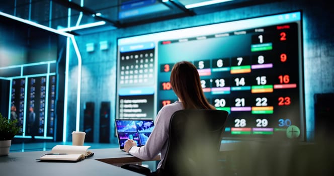 Busy businesswoman organizing appointments and schedules on computer calendar planner.