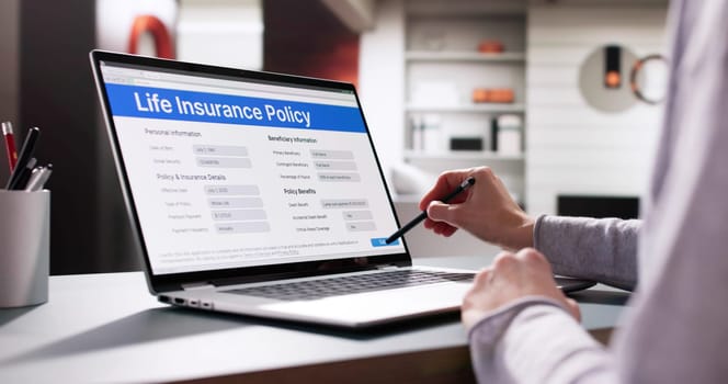 Young woman fills out life insurance policy application form online.