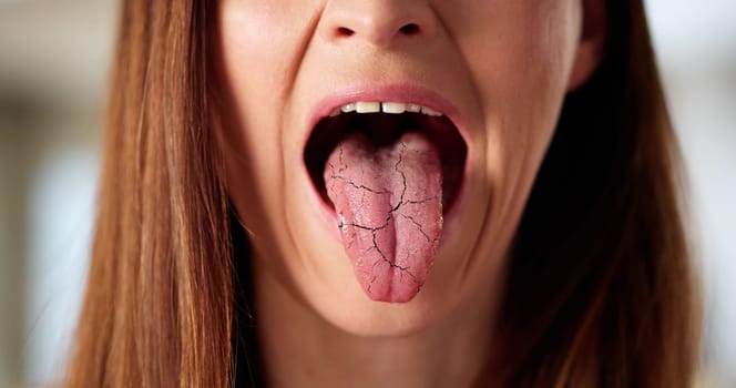 The dentist examines a woman's mouth for oral health issues.