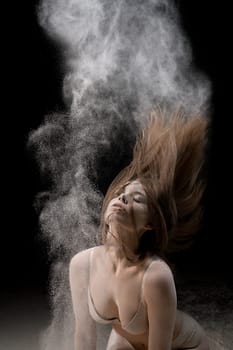 Sexy girl in underwear in white dust cloud cropped view