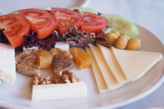 Colorful selection of vegetables and cheese arranged for a snack.