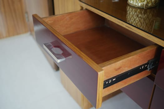 An open drawer shows a wooden interior with a sleek design.