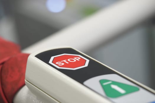 Bold red stop sign clearly displayed on a transit access barrier.
