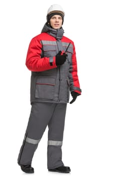 Man in winter workwear, cap and walkie-talkie isolated full-length view
