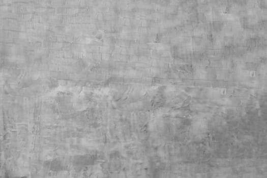 Wall surface with grey unfinished plaster.