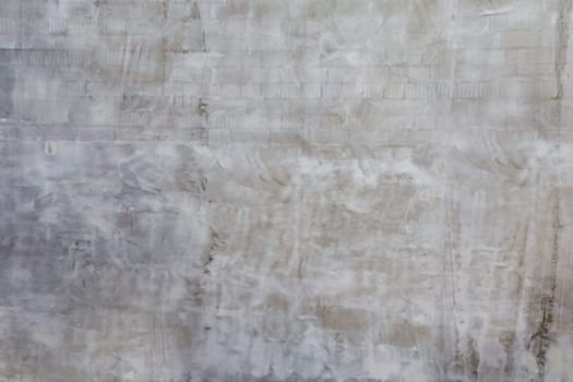 Wall surface with grey unfinished plaster.