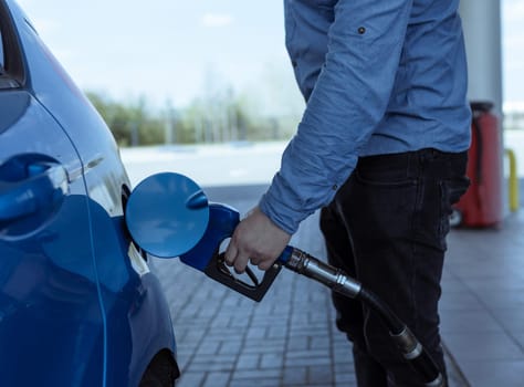 refueling a car with gasoline at a gas station .Rise in fuel prices .Crisis and shortage of gasoline.