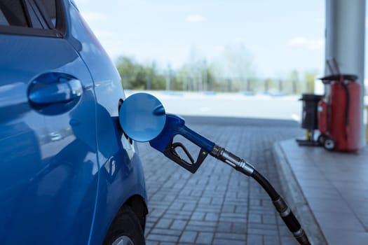 refueling a car with gasoline at a gas station .Rise in fuel prices .Crisis and shortage of gasoline