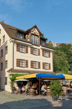 Meersburg, Germany – August 03, 2024: Tourists in a typical traditional wine tavern in the old town of Meersburg on Lake Constance in Germany