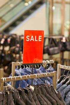 Sign with the inscription Sale to indicate a special offer in a clothing store