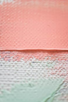 Soft pastel colors merge on the canvas, creating a harmonious blend of peach, white, and green tones. The textured surface invites closer observation of the artistic details.