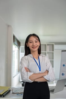 Confident smile businesswoman young asian, happy asian female employee, company sale marketing manager, standing arms crossed in office.