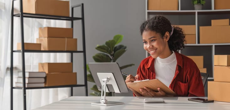 Startup small business entrepreneur SME, asian woman packing cloth in box. Portrait young Asian small business owner home office, online sell marketing delivery, SME e-commerce