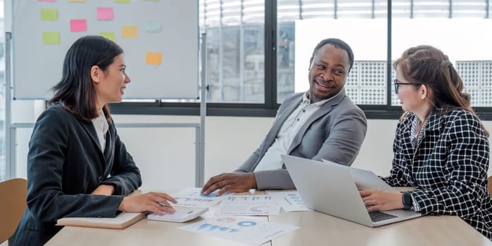 Business People Meeting using laptop computer,calculator,notebook,stock market chart paper for analysis Plans to improve quality next month. Conference Discussion Corporate Concept...