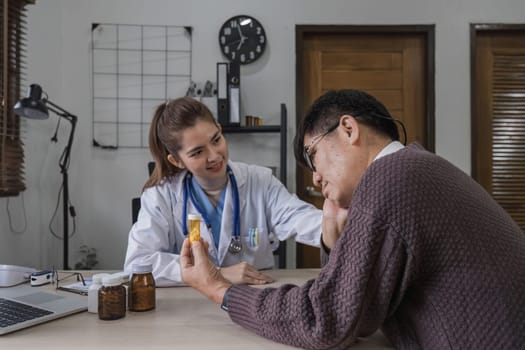 A female doctor is giving advice on diseases and medicine to an elderly male patient. 60s who has a headache Concept of health check and stress disease.