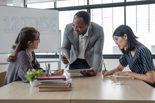 Business People Meeting using laptop computer,calculator,notebook,stock market chart paper for analysis Plans to improve quality next month. Conference Discussion Corporate Concept...