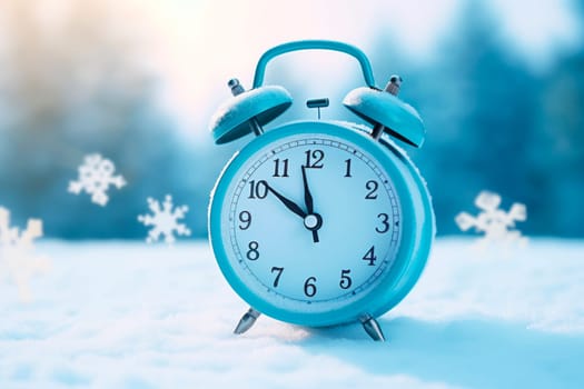 Alarm clock on the background of a winter landscape. Transition to winter time. The concept of Christmas.