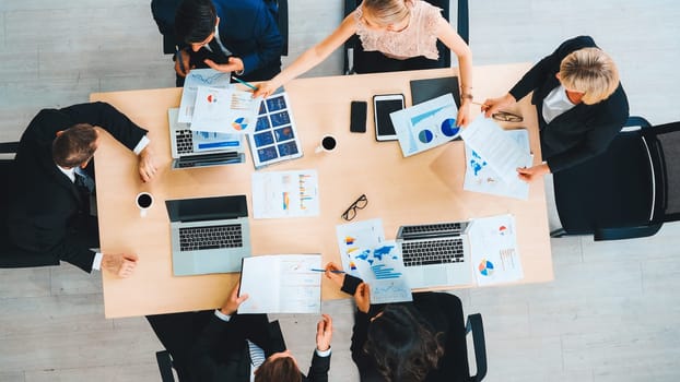 Business people group meeting shot from top view in office . Profession businesswomen, businessmen and office workers working in team conference with project planning document on meeting table . Jivy