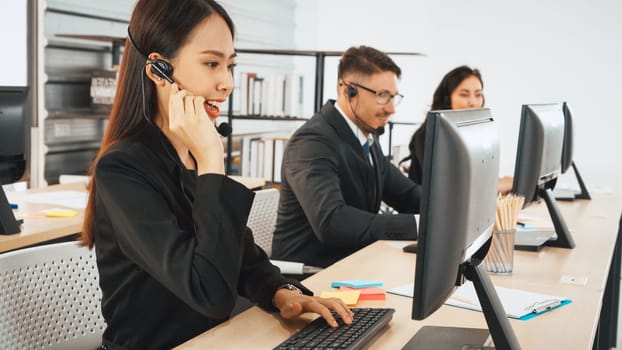 Business people wearing headset working in office to support remote customer or colleague. Call center, telemarketing, customer support agent provide service on telephone video conference call. Jivy