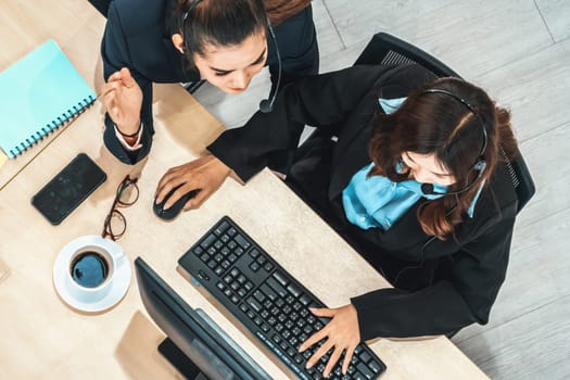 Business people wearing headset shot from top view in office working with computer. Jivy