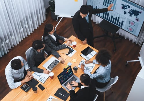 Top view business presentation with data analysis dashboard on TV screen in modern meeting room. Business people brainstorming or working together to plan business marketing strategy. Concord