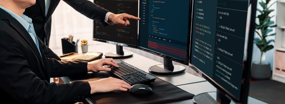 Software development team working together in office, coding script display on computer monitor. Programmer and software engineer working in tech developer company. Trailblazing