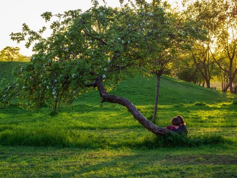 Young loving couple sitting under a tree.
