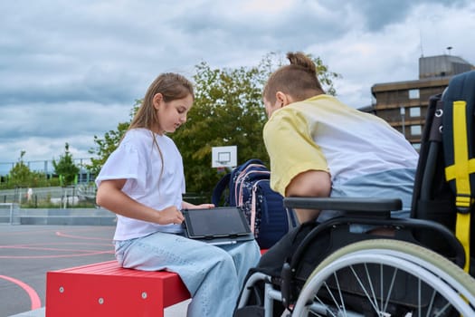 Friendship communication of children of boy in wheelchair and girl. Classmates sitting talking after school lessons. Education, disability, inclusiveness concept