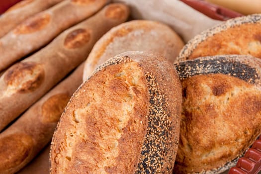 Various loaves of home made bread on display at a market.