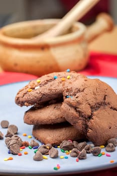 Close up photo of chocolate chip cookies with color sprinkles on them.