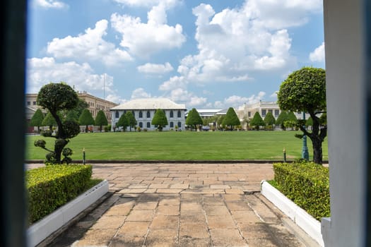 A landscape view with manicured lawns and modern buildings under a vibrant blue sky that captivates, Bangkok, Thailand