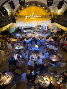 Russia, St.Petersburg, 08 February 2025: The jazz quartet in the spotlight plays on the stage of the famous Igor Butman jazz club, the bright appearance of the musicians, beautiful instruments. High quality photo